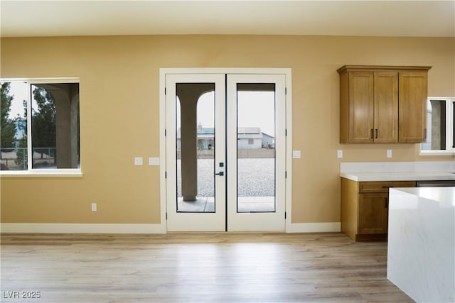 3080 S Prairie Ave, Pahrump, NV 89048 - doorway with french doors, light wood-style flooring, and baseboards