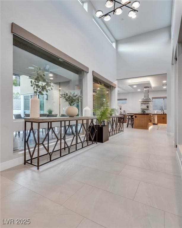 interior space with a towering ceiling and baseboards