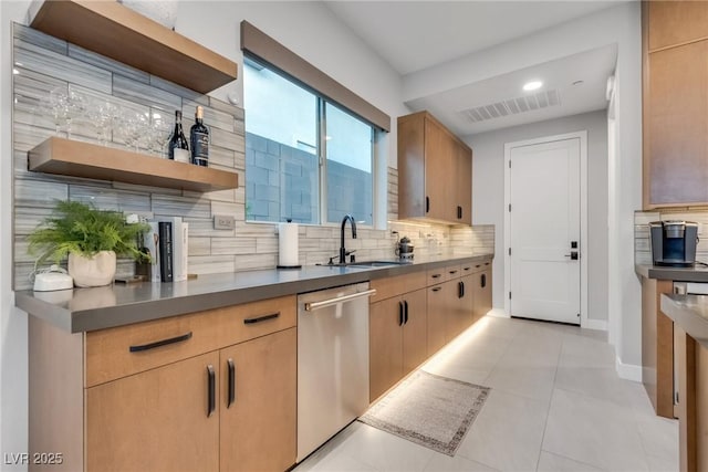 kitchen with decorative backsplash, visible vents, a sink, and stainless steel dishwasher