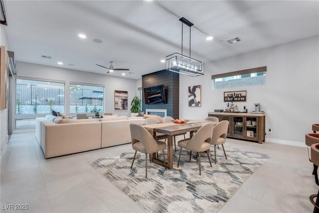 dining room featuring recessed lighting, a large fireplace, visible vents, and baseboards