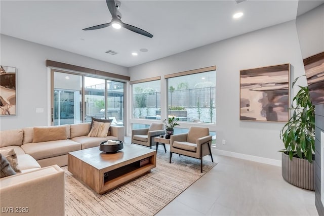 living room featuring recessed lighting, visible vents, plenty of natural light, and baseboards