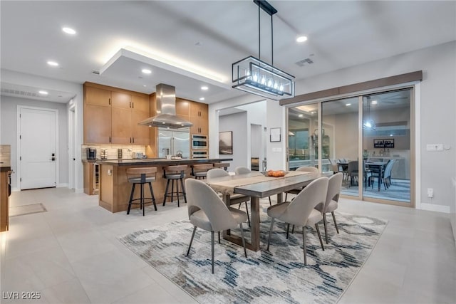 dining room with baseboards, visible vents, and recessed lighting