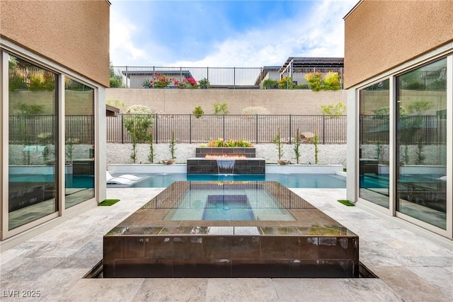 view of swimming pool with an in ground hot tub, a fenced backyard, and a fenced in pool