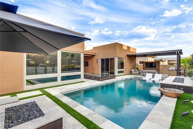 pool featuring a fire pit, an in ground hot tub, exterior kitchen, and a patio