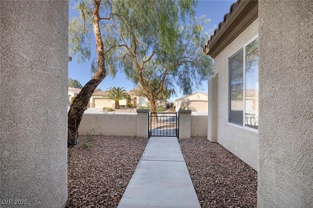 view of yard featuring fence and a gate