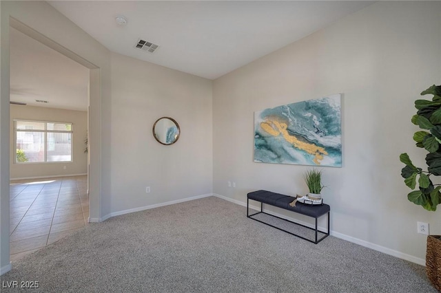 interior space with carpet flooring, visible vents, and baseboards