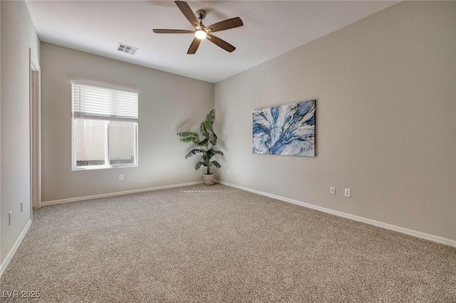 unfurnished room featuring carpet floors, baseboards, visible vents, and a ceiling fan