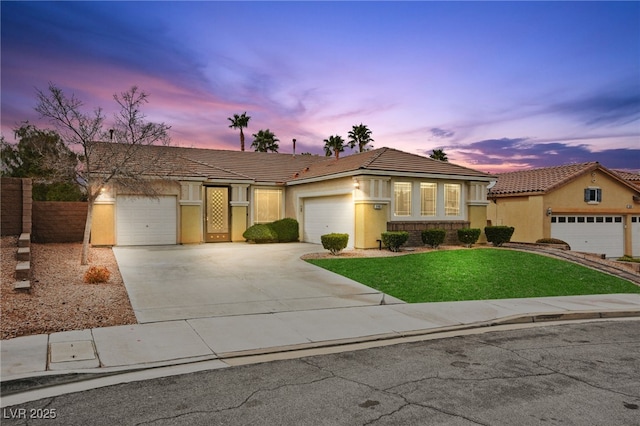 view of front of house with fence, a front yard, stucco siding, a garage, and driveway