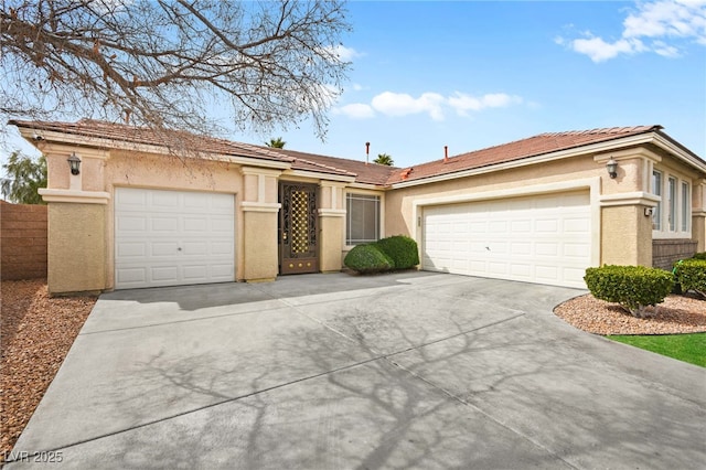 ranch-style house with concrete driveway, a garage, and stucco siding