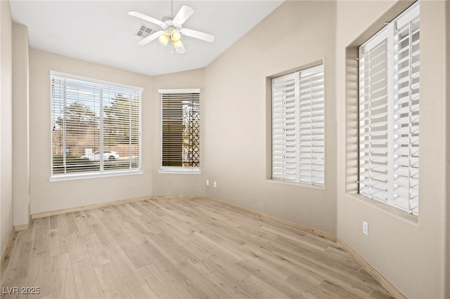 unfurnished room featuring visible vents, wood finished floors, a ceiling fan, and vaulted ceiling