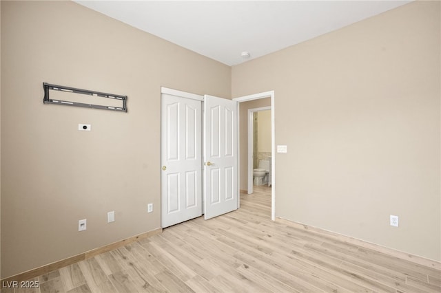 unfurnished bedroom featuring light wood finished floors and baseboards