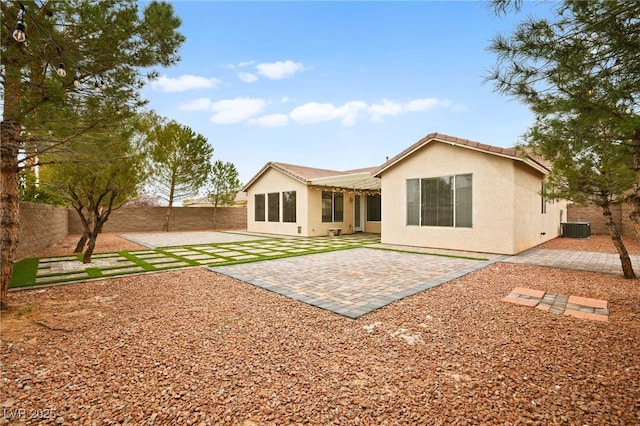 back of property featuring a patio, cooling unit, a fenced backyard, and stucco siding