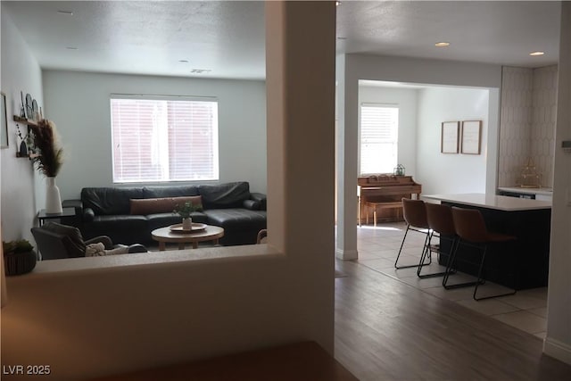 living room featuring light tile patterned flooring and plenty of natural light