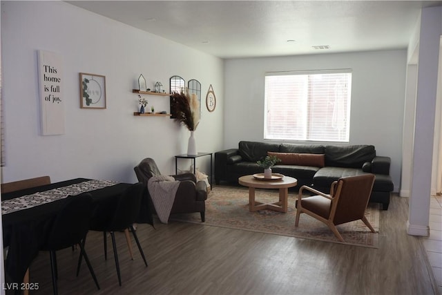 living room with visible vents and wood finished floors