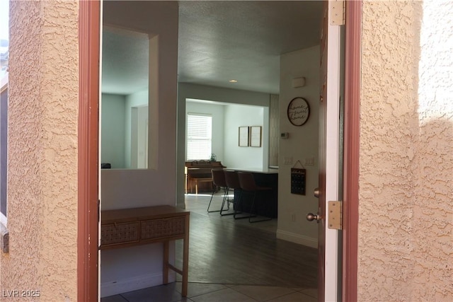 hall featuring baseboards and wood finished floors