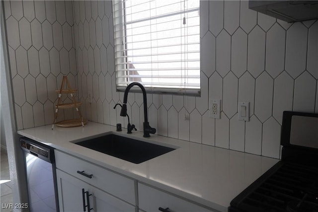 kitchen with a sink, white cabinetry, gas stove, light countertops, and dishwasher