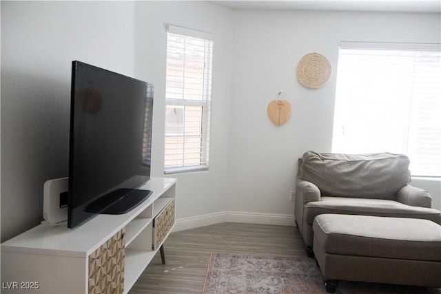 sitting room with wood finished floors and baseboards