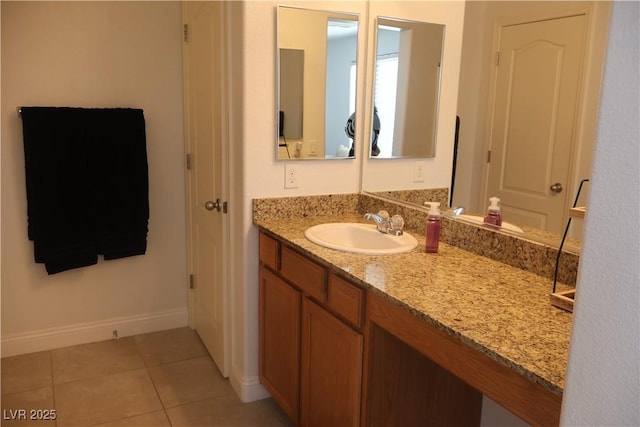 bathroom featuring tile patterned flooring, vanity, and baseboards