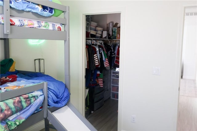 bedroom featuring a closet and a spacious closet