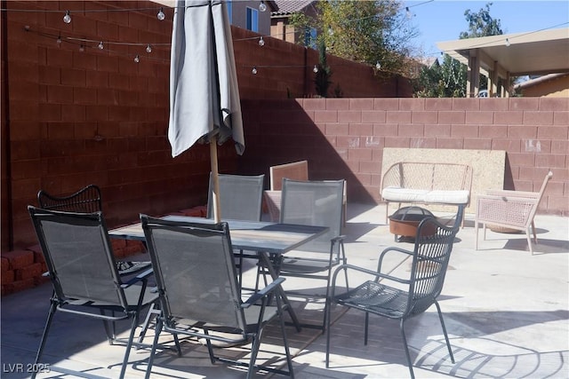 view of patio / terrace with outdoor dining space and fence