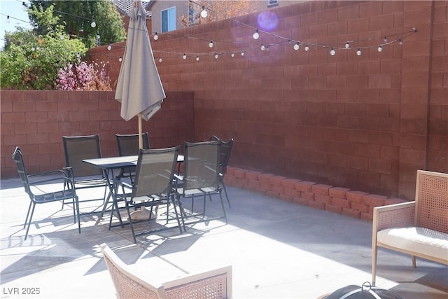 view of patio / terrace featuring outdoor dining space and fence