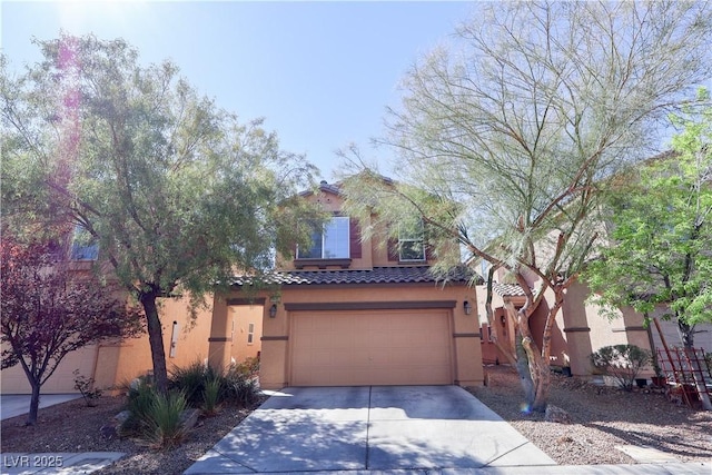view of front facade featuring a tile roof, driveway, a garage, and stucco siding