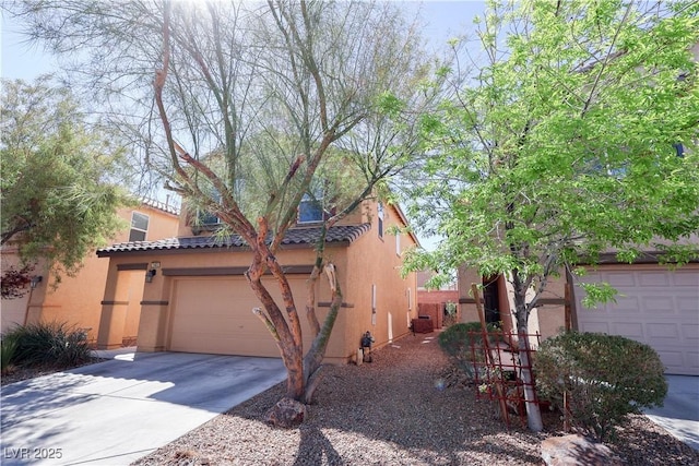 view of property exterior featuring stucco siding, an attached garage, a tile roof, and concrete driveway