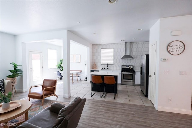 living area with light tile patterned floors and baseboards