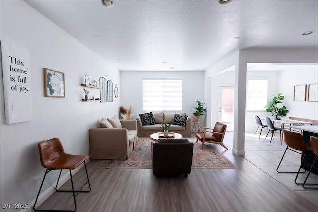 living area featuring baseboards and wood finished floors