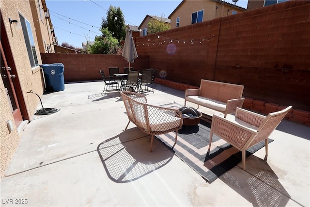 view of patio / terrace with a fenced backyard, outdoor dining space, and an outdoor hangout area