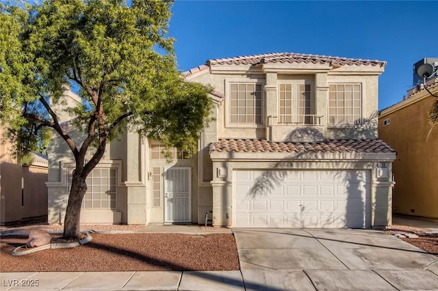 mediterranean / spanish-style house featuring a garage, driveway, a tiled roof, and stucco siding