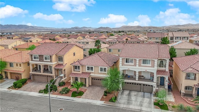 drone / aerial view featuring a residential view and a mountain view