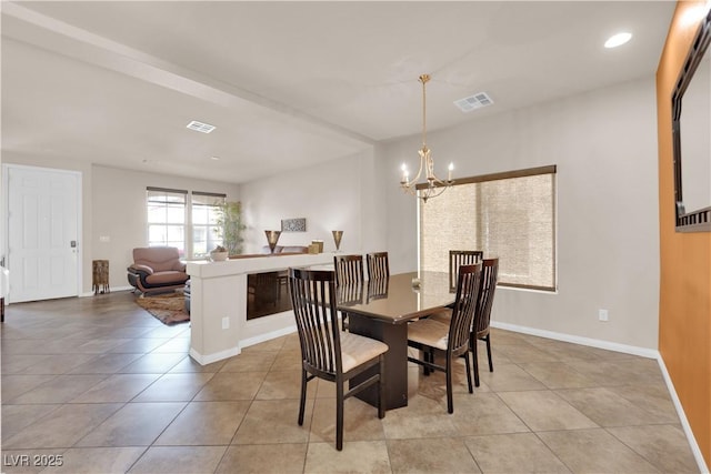 dining space with a chandelier, visible vents, and baseboards