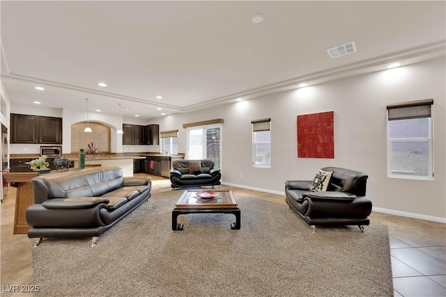 living room featuring light tile patterned floors, baseboards, visible vents, and recessed lighting