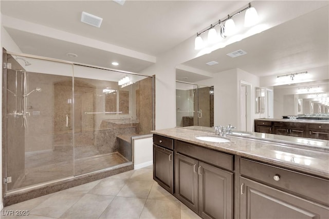 bathroom featuring tile patterned floors, a shower stall, visible vents, and vanity