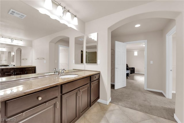 full bath featuring visible vents, vanity, baseboards, and tile patterned floors