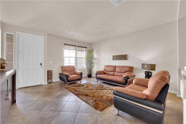 living room with visible vents, baseboards, and light tile patterned flooring