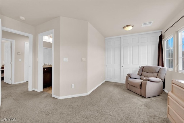 unfurnished room with carpet, visible vents, and baseboards