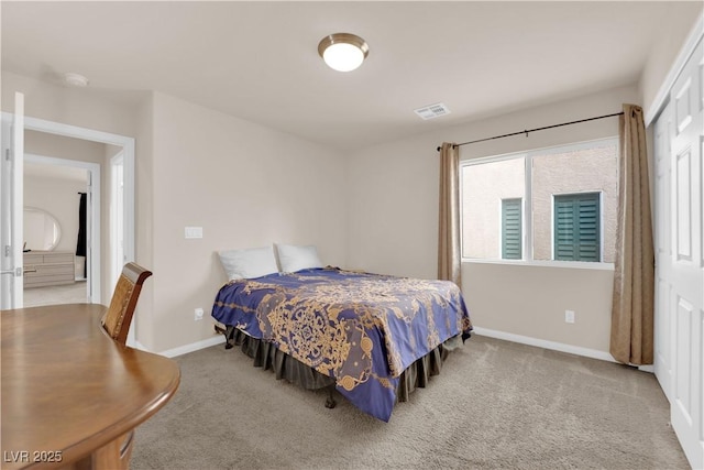 carpeted bedroom with visible vents and baseboards