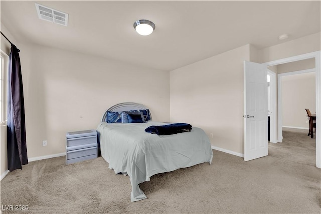 carpeted bedroom with visible vents and baseboards