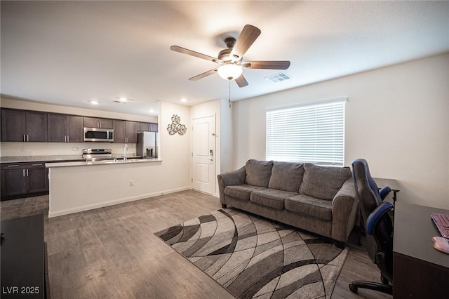 living area featuring recessed lighting, visible vents, ceiling fan, wood finished floors, and baseboards