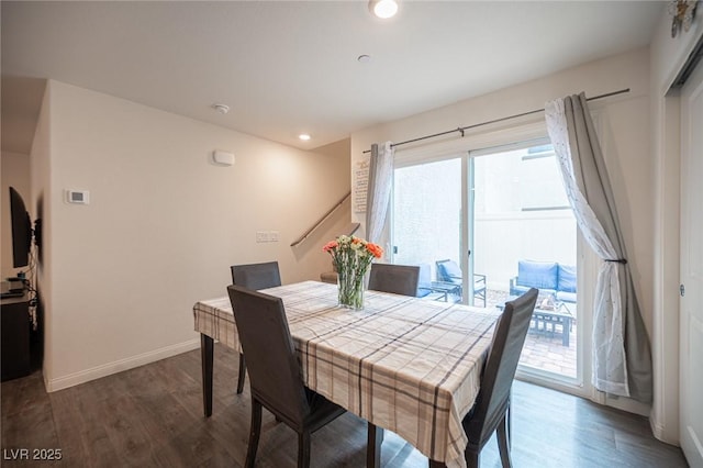 dining space with baseboards, wood finished floors, and recessed lighting