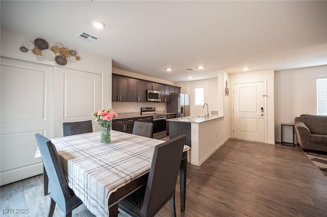 dining room with recessed lighting, visible vents, dark wood finished floors, and baseboards