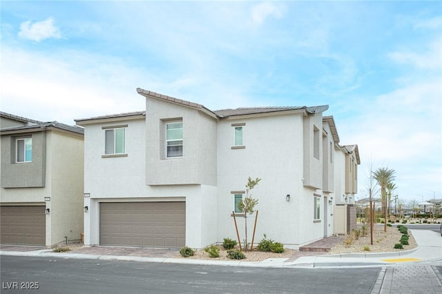 view of front facade featuring an attached garage and stucco siding