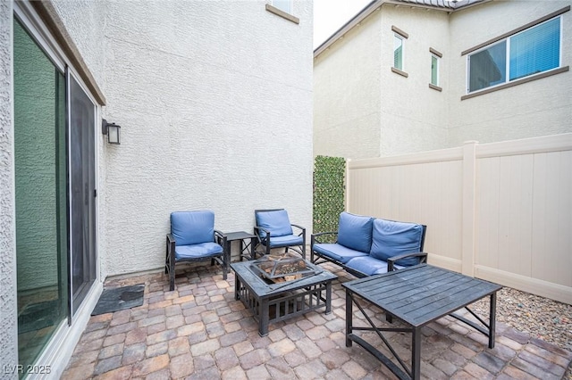 view of patio featuring outdoor lounge area and fence