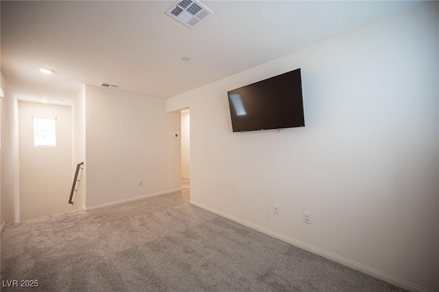 basement featuring carpet, visible vents, and baseboards