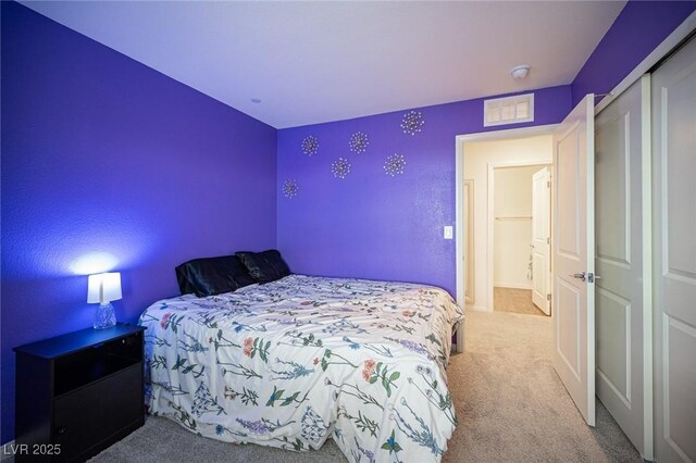 bedroom featuring carpet floors, a closet, and visible vents