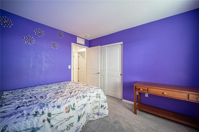 carpeted bedroom featuring a closet