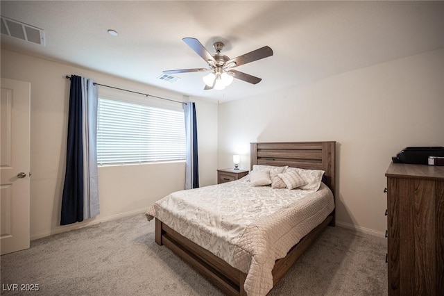 carpeted bedroom with a ceiling fan, visible vents, and baseboards