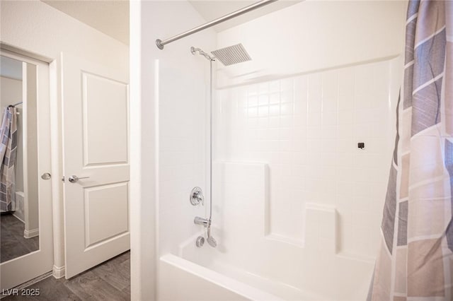 bathroom with a tub to relax in, curtained shower, and wood finished floors